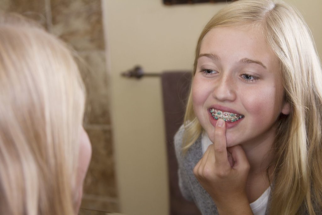 person eating braces-friendly foods at a table