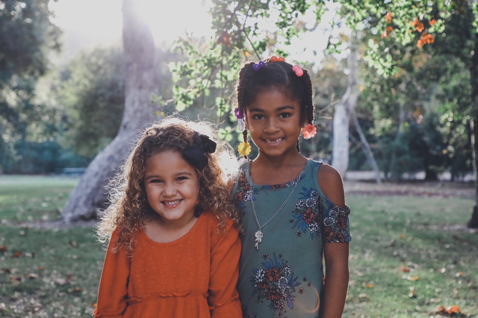 Smiling children outdoors, showcasing bright smiles, representing the positive outcomes of orthodontic treatment at Rice Orthodontics in Jacksonville.